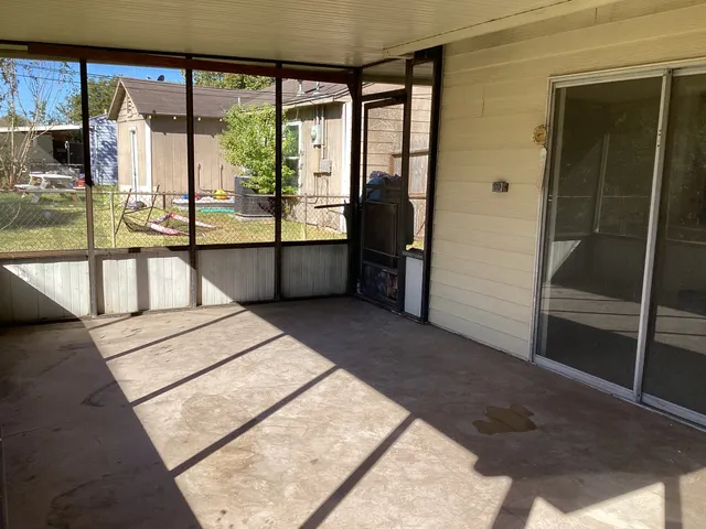 a front view of a house with a yard covered in snow