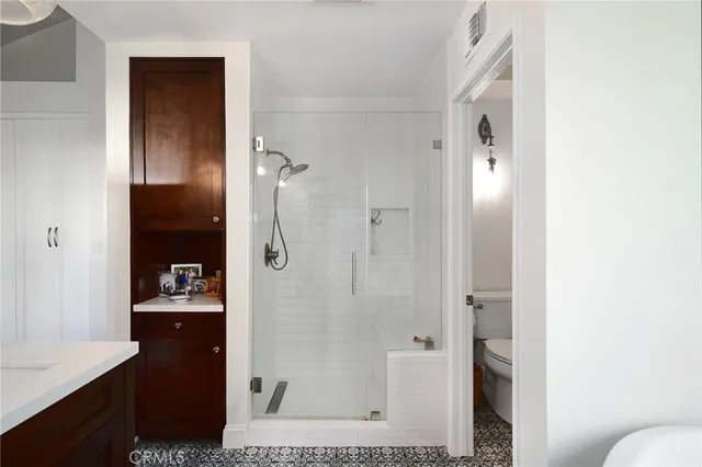 a walk in closet with a mirror