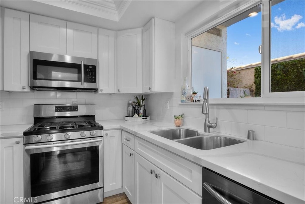 28178 Ridgecove Court South Rancho Palos Verdes, CA 90275 - Photo 12 of 45 a kitchen with white cabinets a sink stove and microwave