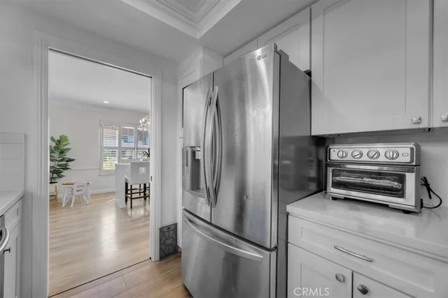 a kitchen with stainless steel appliances a refrigerator and a stove top oven