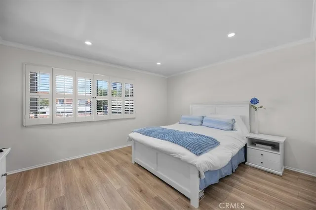 a spacious bedroom with a bed and a window