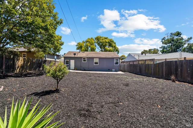a view of a backyard with sitting area
