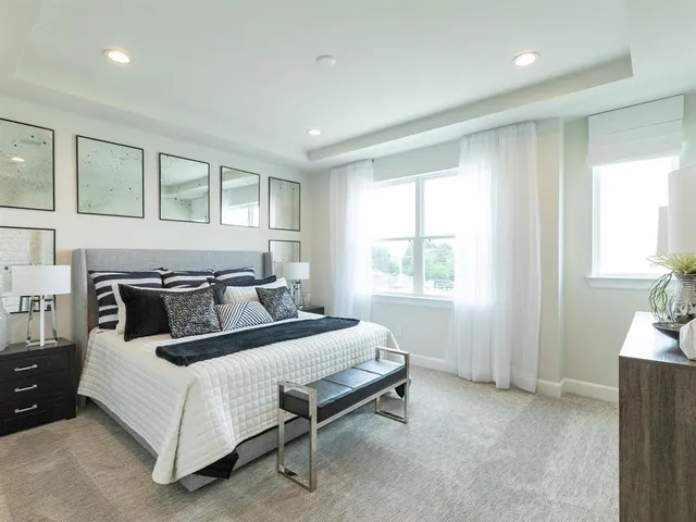 a bed sitting in a bedroom next to a window