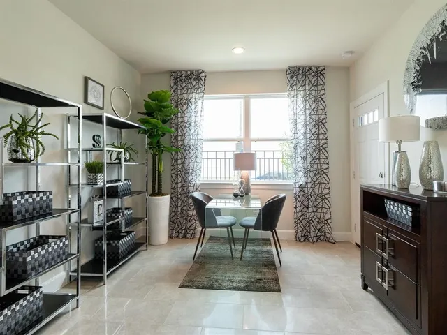 a living room with furniture a window and a flat screen tv