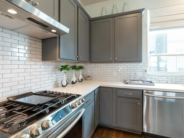 a kitchen with a sink stove and cabinets