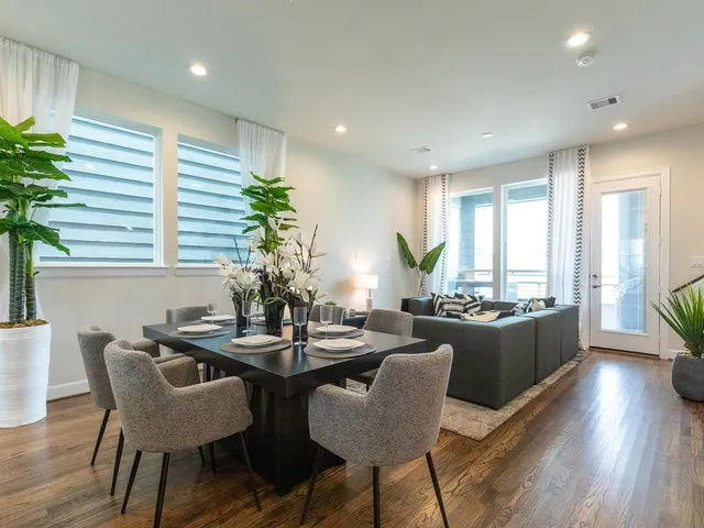 a dining room with furniture and wooden floor