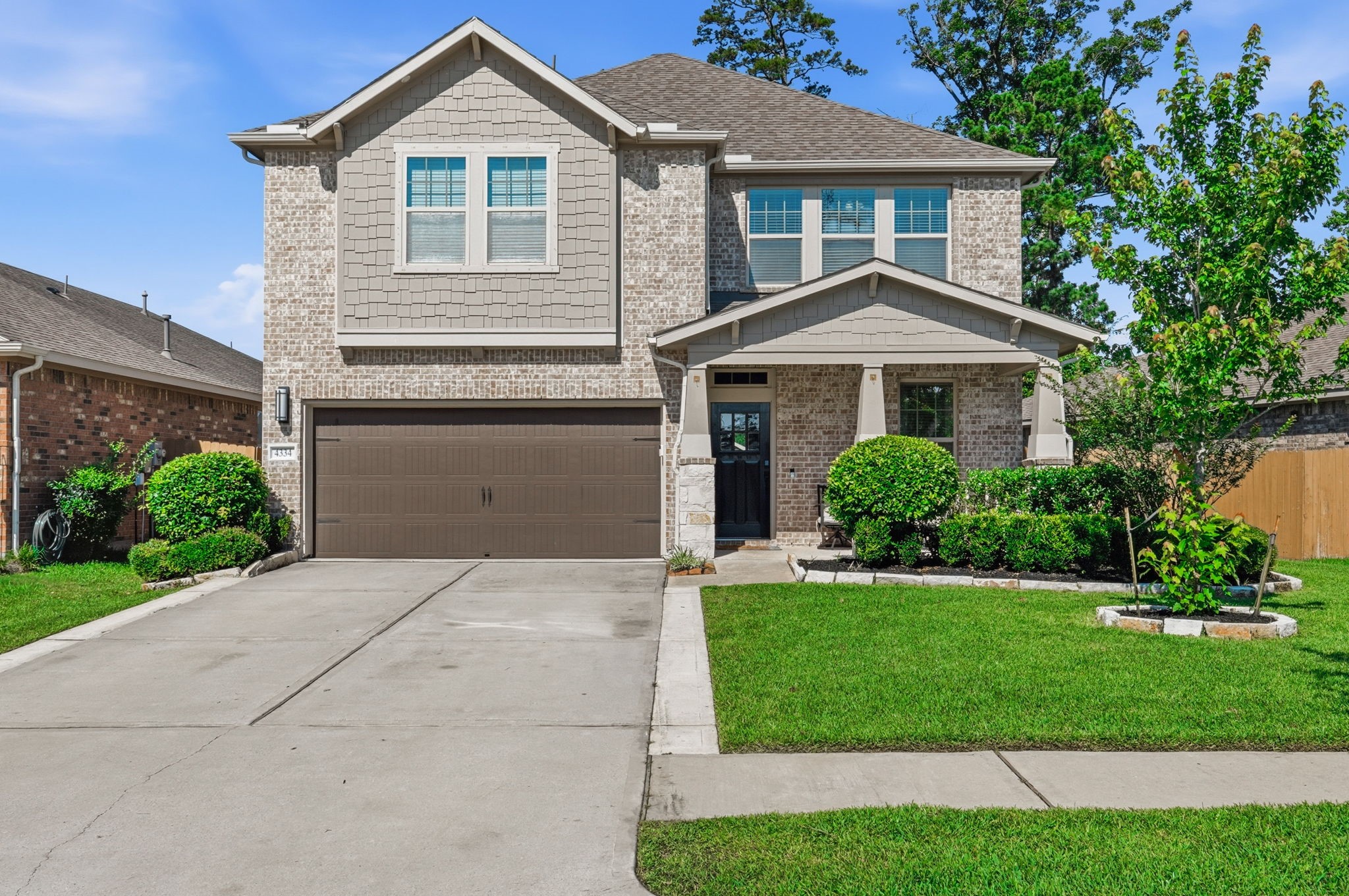 4334 Umber Shadow Drive Spring, TX 77386 - Photo 38 of 45 Two-story brick exterior features attractive curb appeal, a covered front entry, manicured landscaping, and a spacious driveway leading to the attached garage.
