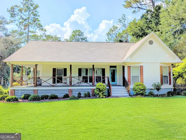 a front view of a house with a garden and plants