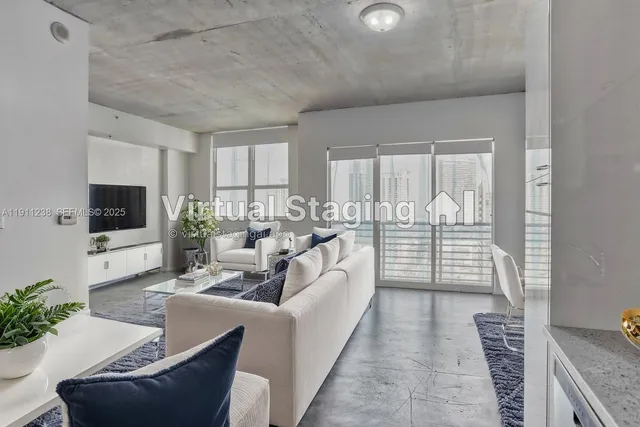 a living room with furniture a flat screen tv and a large window