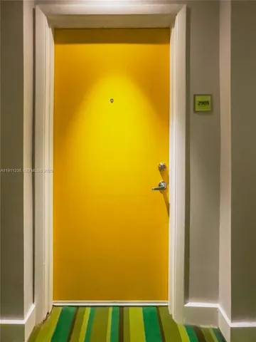 a swimming pool with a large window and painted walls