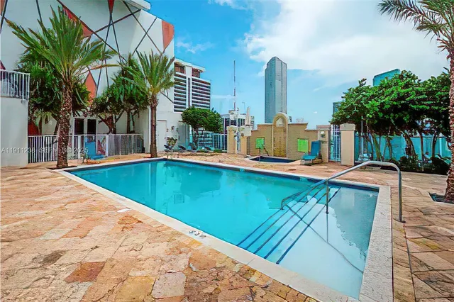 a swimming pool with outdoor seating and yard