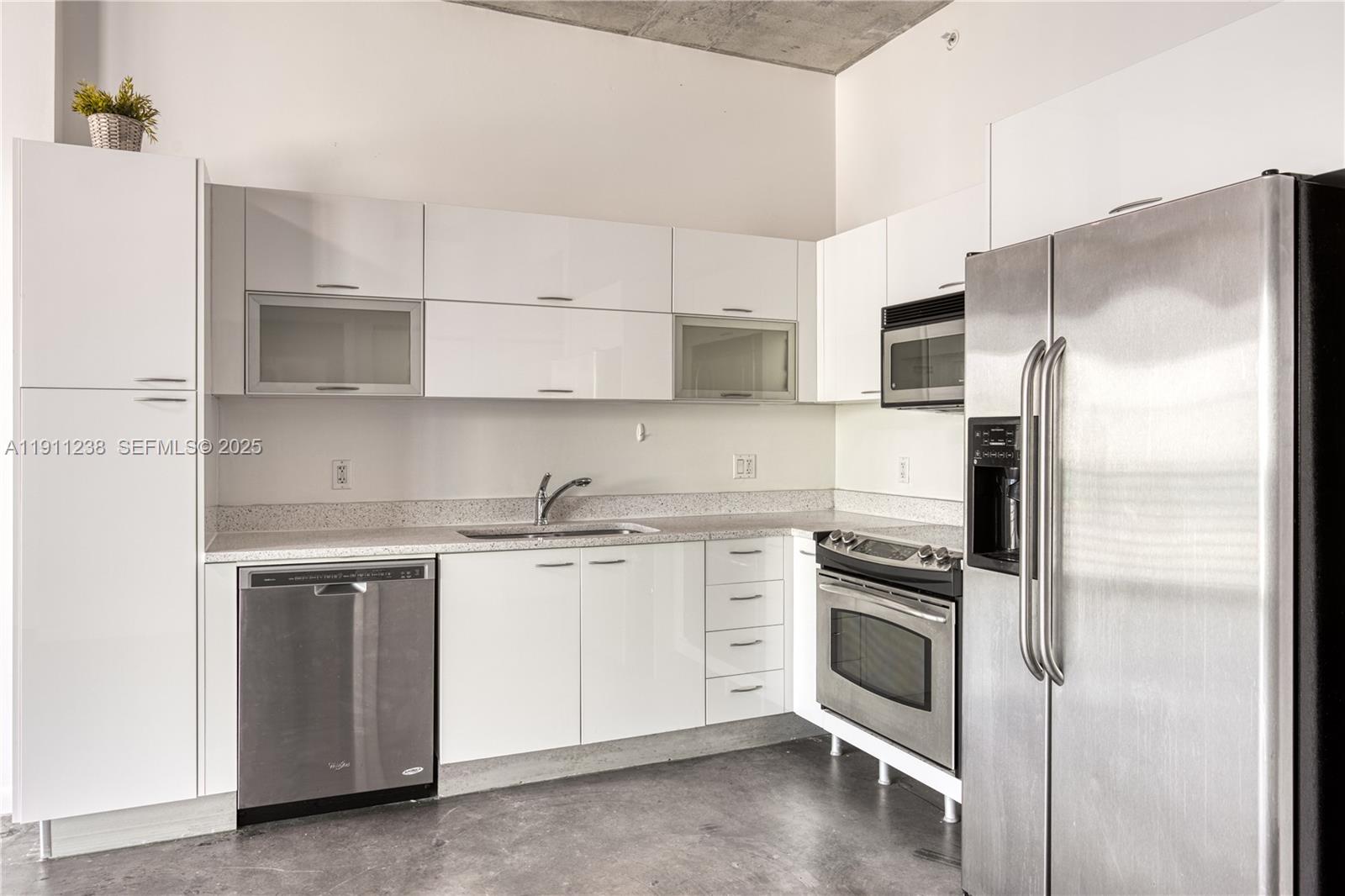 133 Northeast 2nd Avenue, Unit 2905 Miami, FL 33132 - Photo 5 of 17 a kitchen with cabinets stainless steel appliances and a counter space