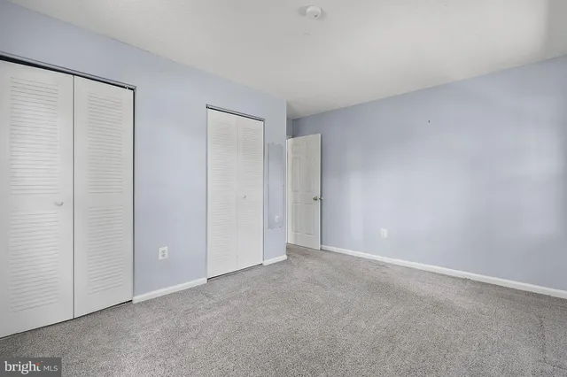 a view of an empty room and closet area