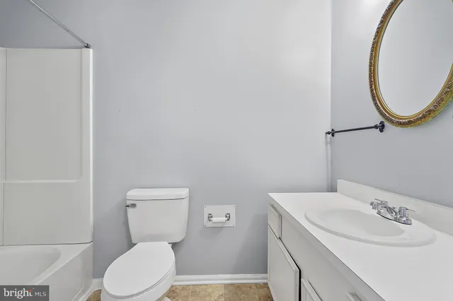 a white toilet sitting next to a bathroom sink