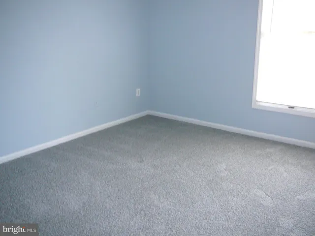 a view of an empty room and a window