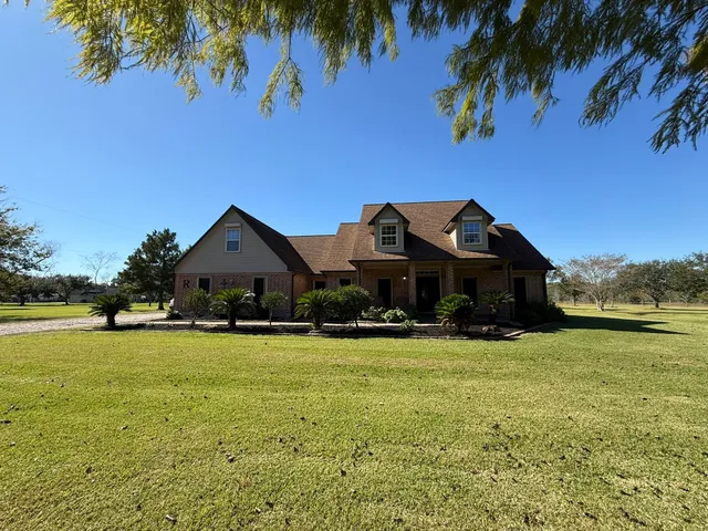 a front view of a house with a big yard