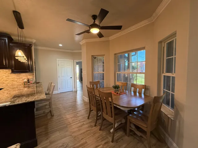 a view of a dining room with furniture and wooden floor