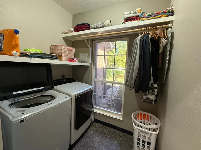 a utility room with closet dryer and washer