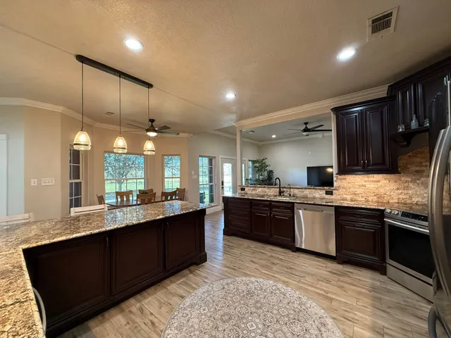 a large kitchen with lots of counter space sink and a stove