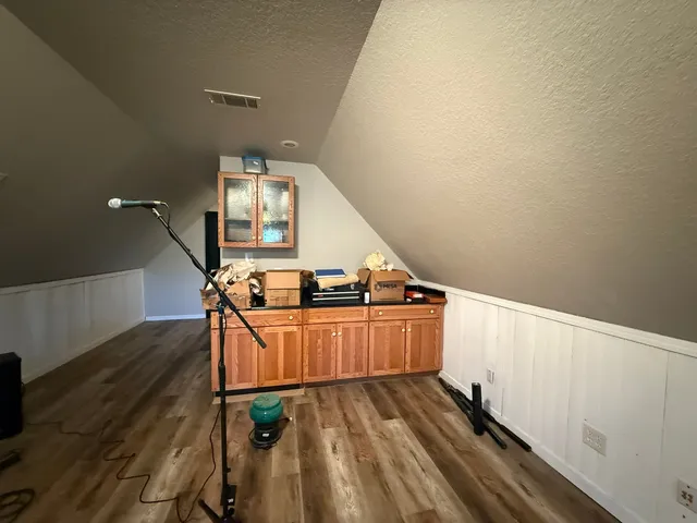 a view of a room with wooden floor