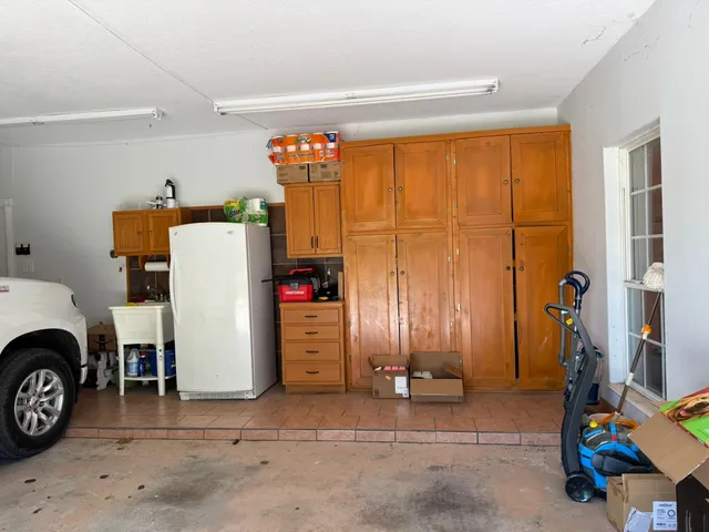a view of storage and utility room with closet and toys
