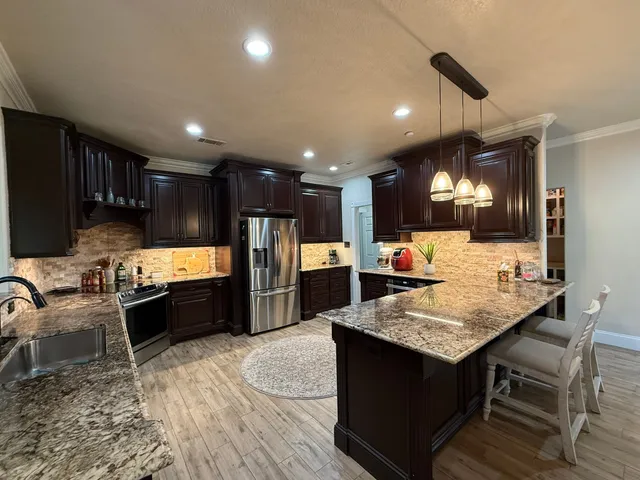 a large kitchen with a table and chairs