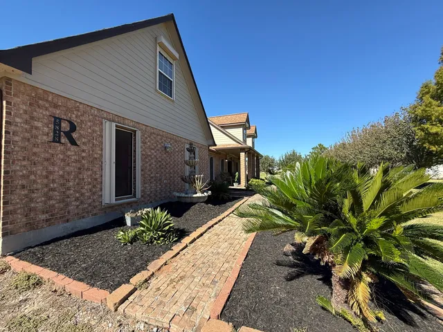 a front view of a house with garden