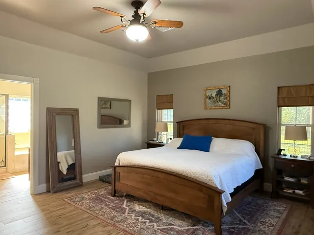 a bedroom with a bed and a chandelier