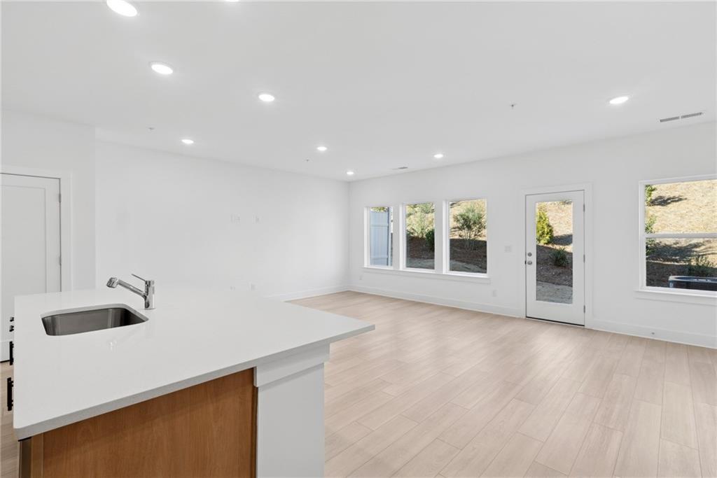 187 Redbud Road Canton, GA 30114 - Photo 4 of 13 a view of an empty room with wooden floor and a window