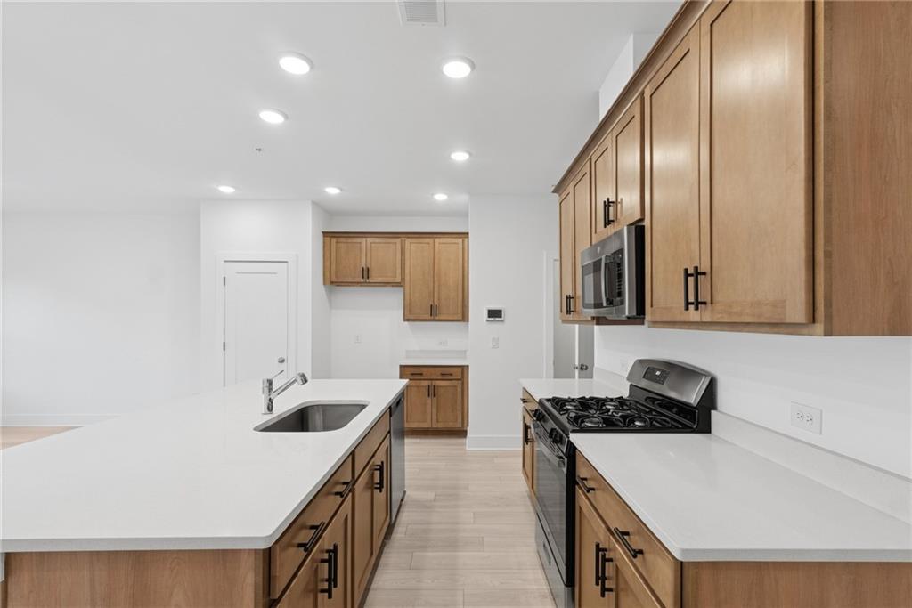 187 Redbud Road Canton, GA 30114 - Photo 5 of 13 a kitchen with a sink stove and cabinets