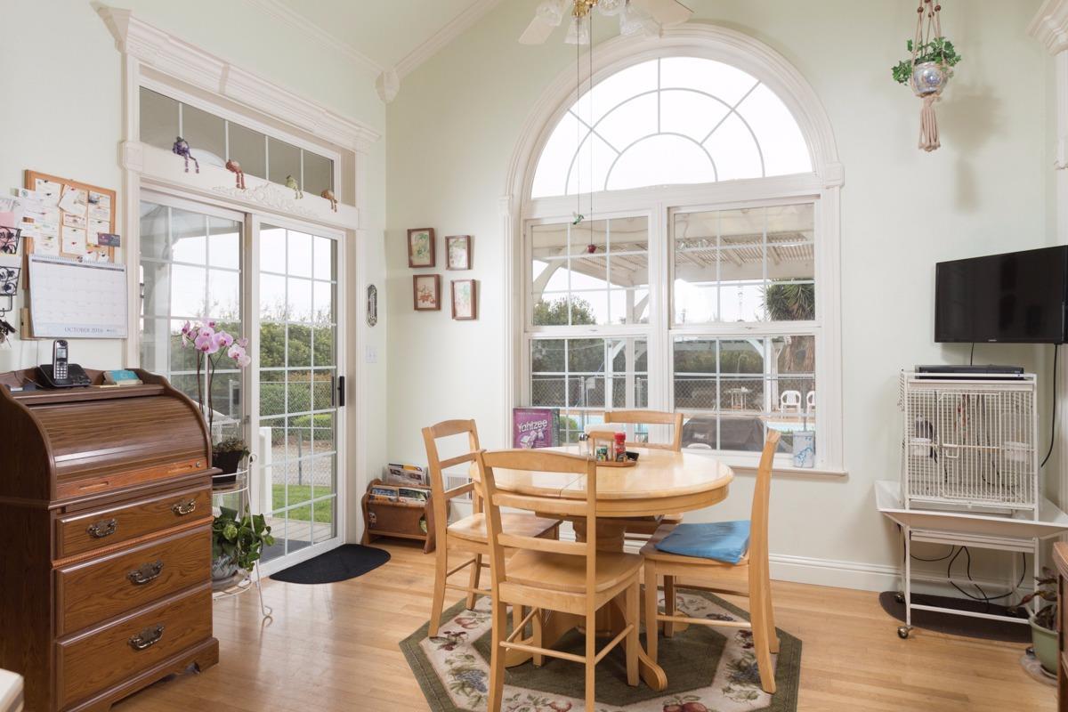 271 Wildwood Road Arbuckle, CA 95912 - Photo 3 of 7 a dining room with wooden floor a glass table and chairs