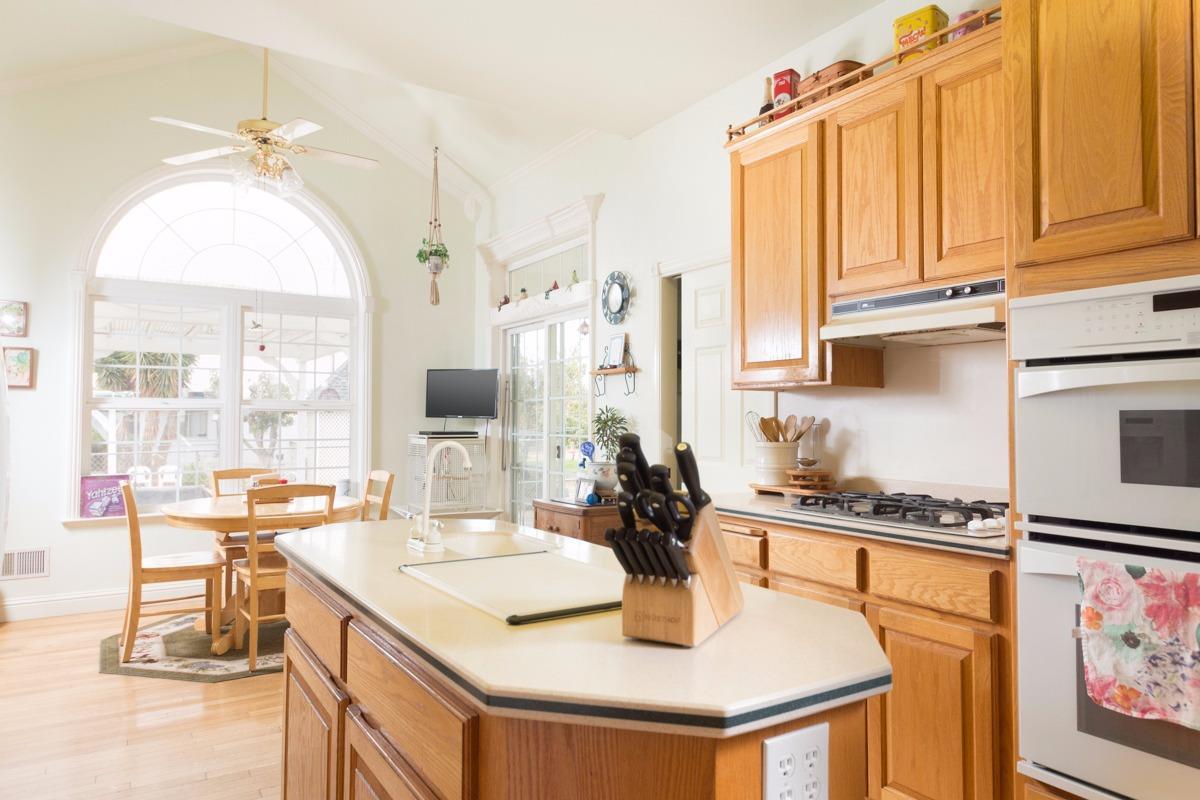 271 Wildwood Road Arbuckle, CA 95912 - Photo 4 of 7 a kitchen with a sink a stove and a refrigerator