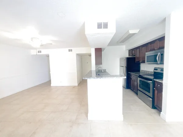a kitchen with kitchen island sink stainless steel appliances and cabinets
