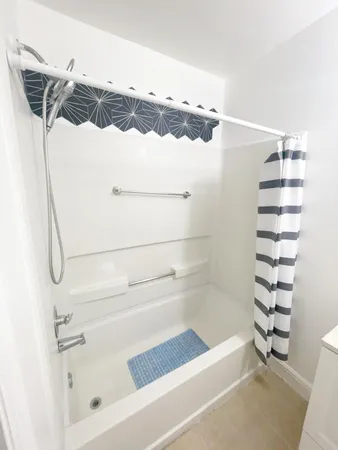 a bathroom with a bathtub and a shower