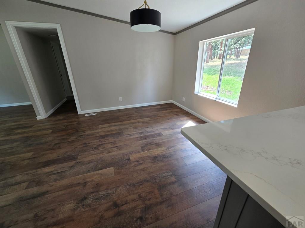 8229 Green Lane Rye, CO 81069 - Photo 7 of 24 an empty room with wooden floor and windows