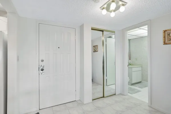 a bathroom with a granite countertop toilet a sink and a mirror