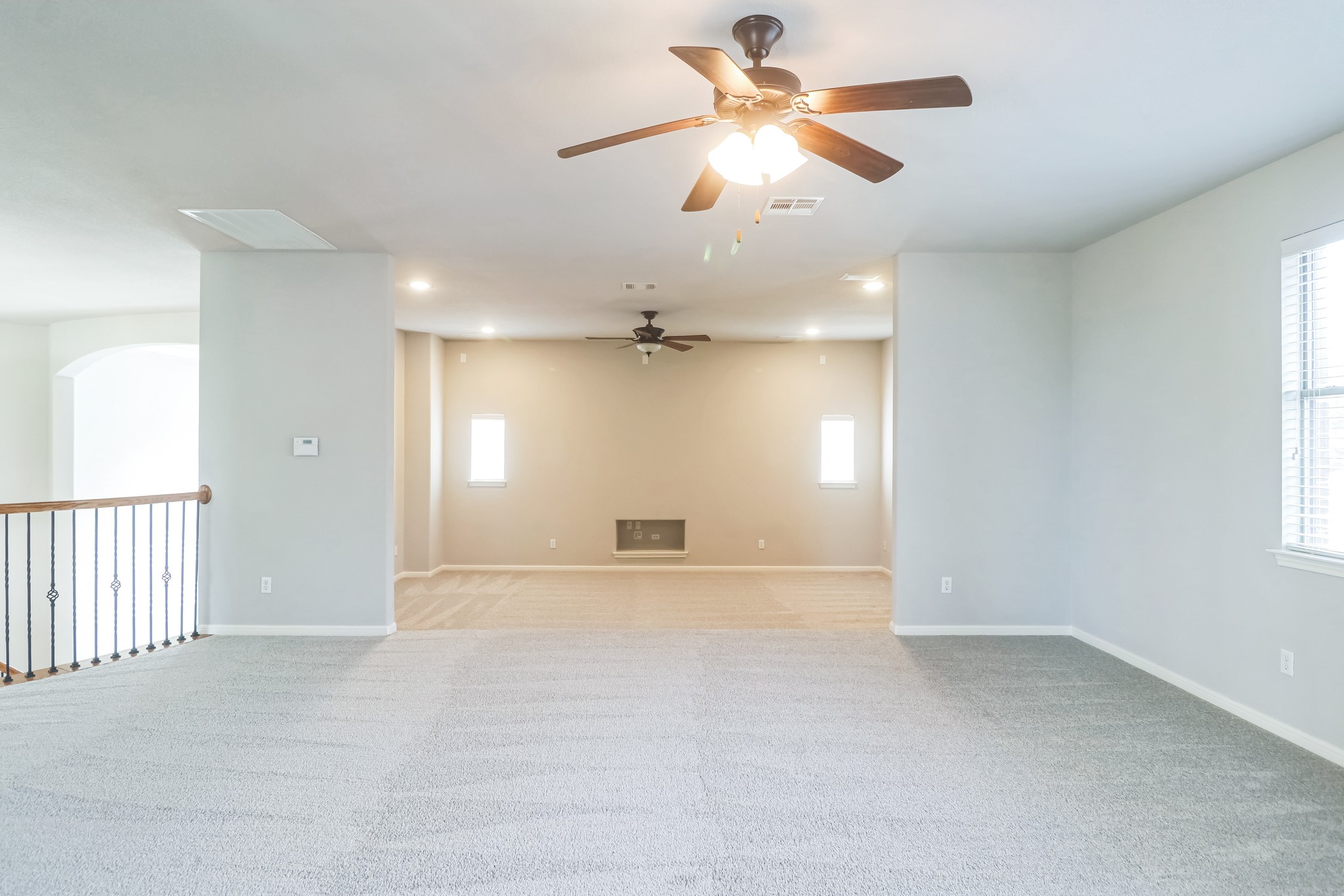 3913 Remington Road Cedar Park, TX 78613 - Photo 24 of 32 A spacious upper-level loft features wall-to-wall carpeting and multiple window openings.