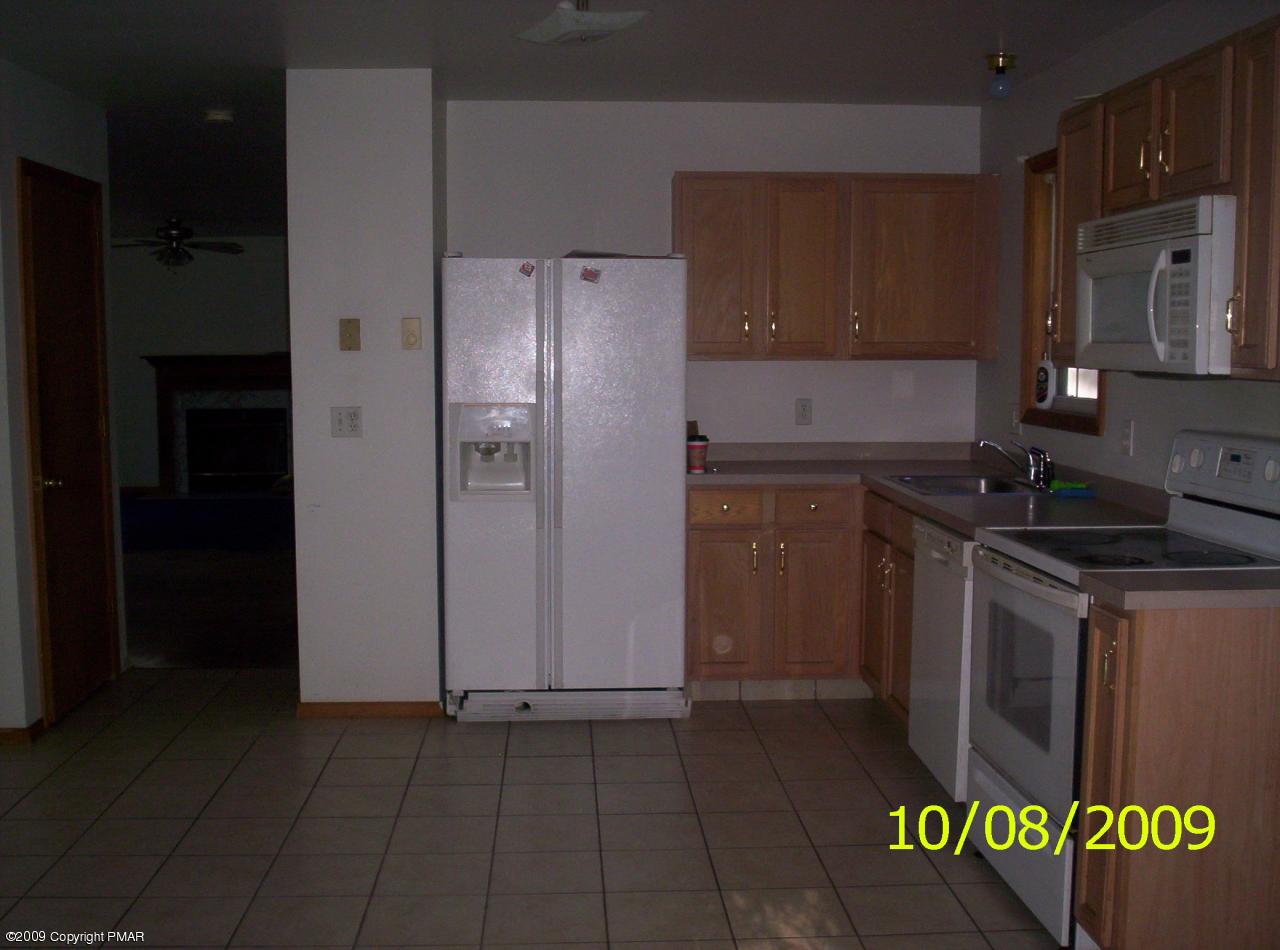 3312 Cotswald Road Tobyhanna, PA 18466 - Photo 2 of 9 a kitchen with granite countertop a refrigerator and a stove top oven
