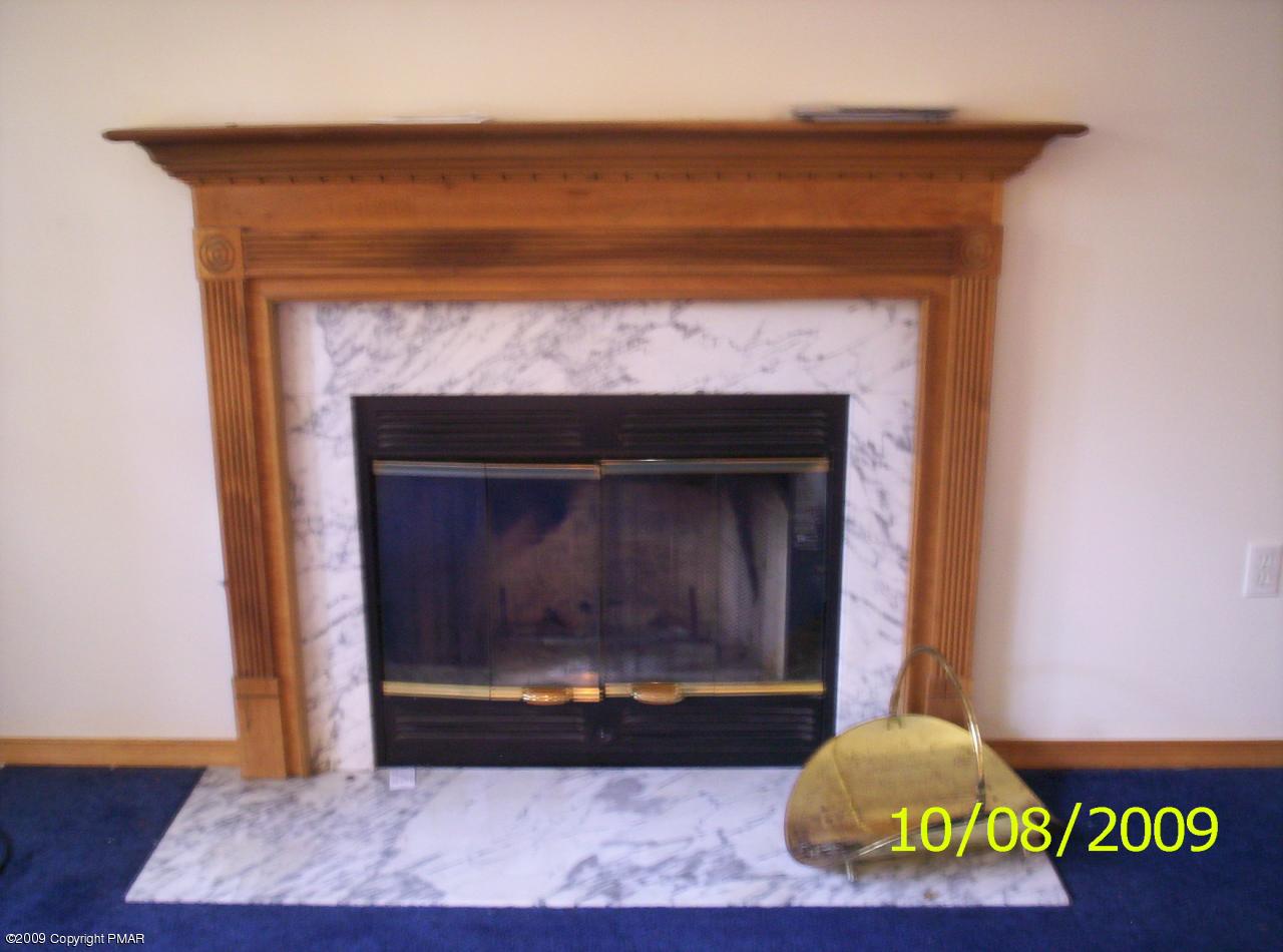 3312 Cotswald Road Tobyhanna, PA 18466 - Photo 5 of 9 a living room with a fireplace and a wooden floor