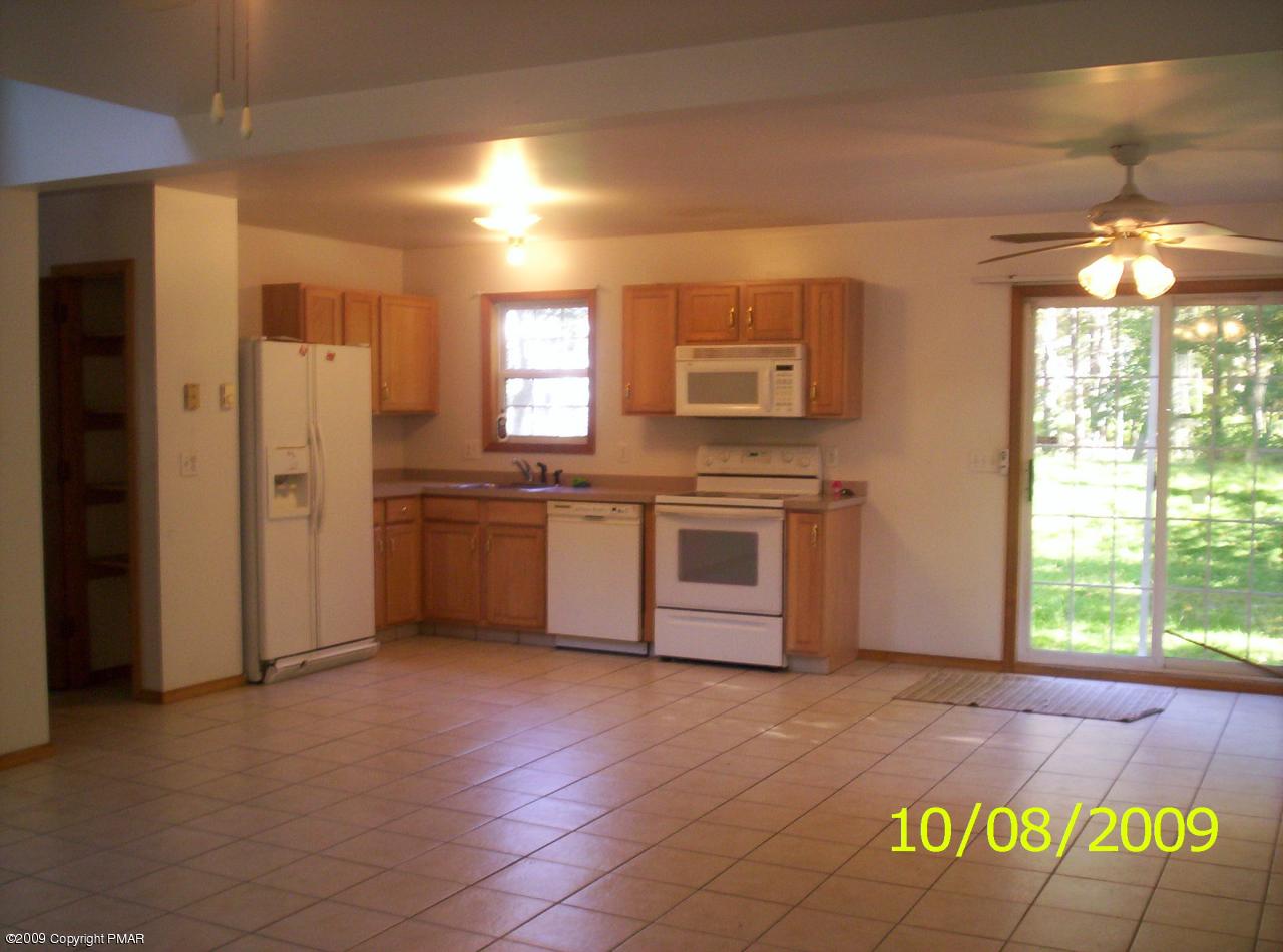 3312 Cotswald Road Tobyhanna, PA 18466 - Photo 6 of 9 a kitchen with stainless steel appliances granite countertop a stove a sink and a refrigerator