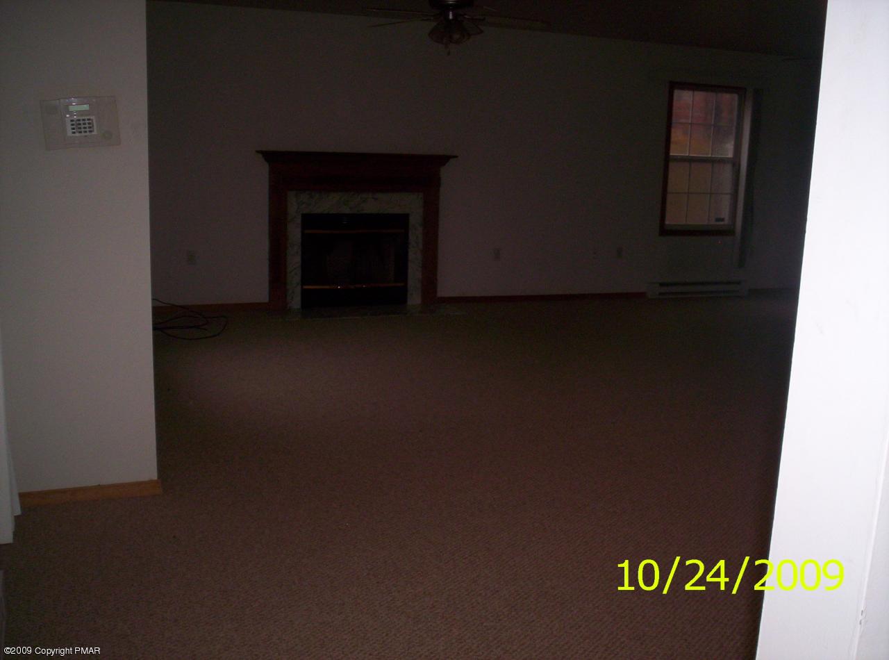 3312 Cotswald Road Tobyhanna, PA 18466 - Photo 8 of 9 a view of an empty room with a fireplace