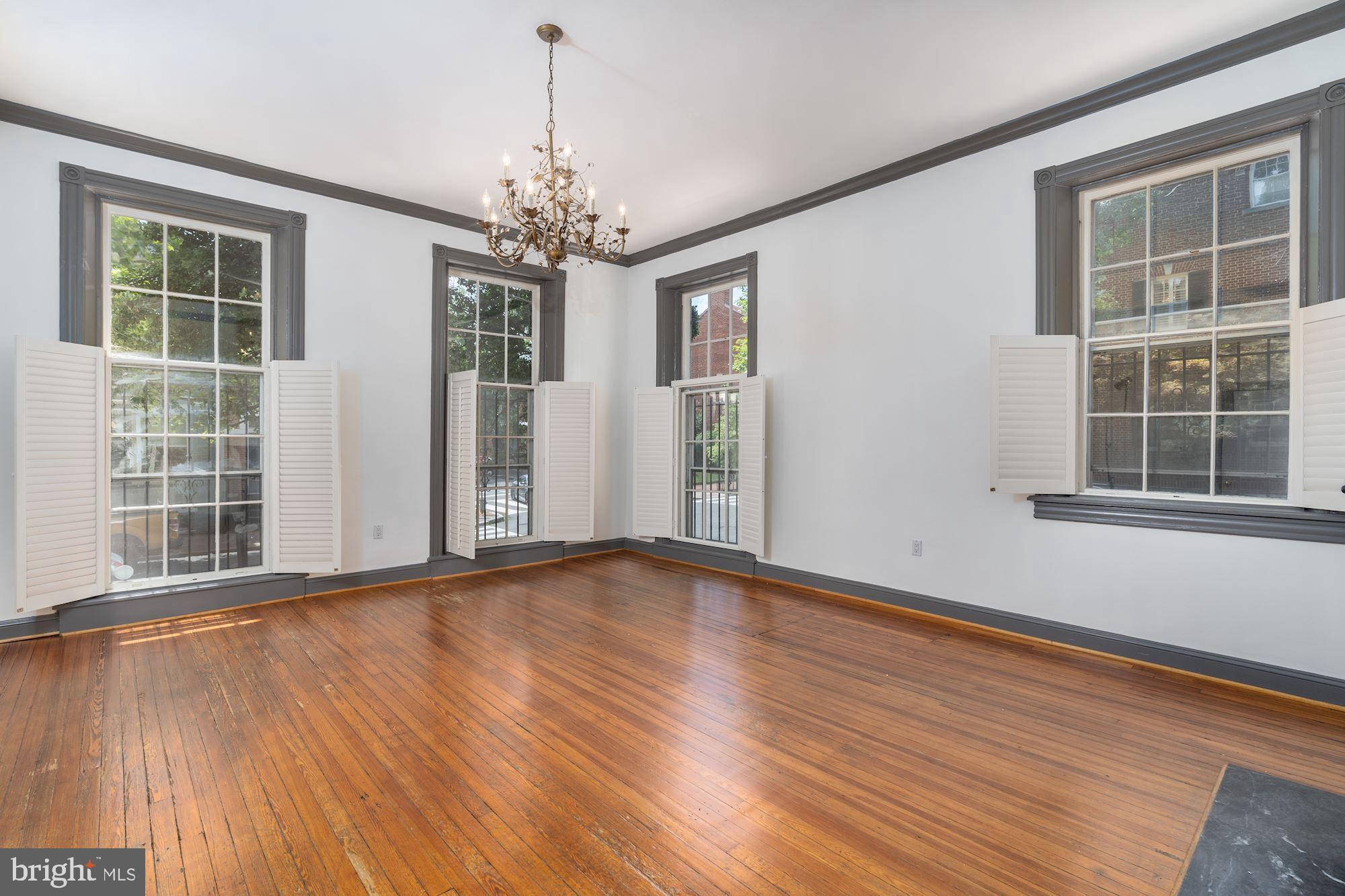 3267 N Street Northwest, Unit 2 Washington, DC 20007 - Photo 1 of 21 a view of an empty room with wooden floor and a window