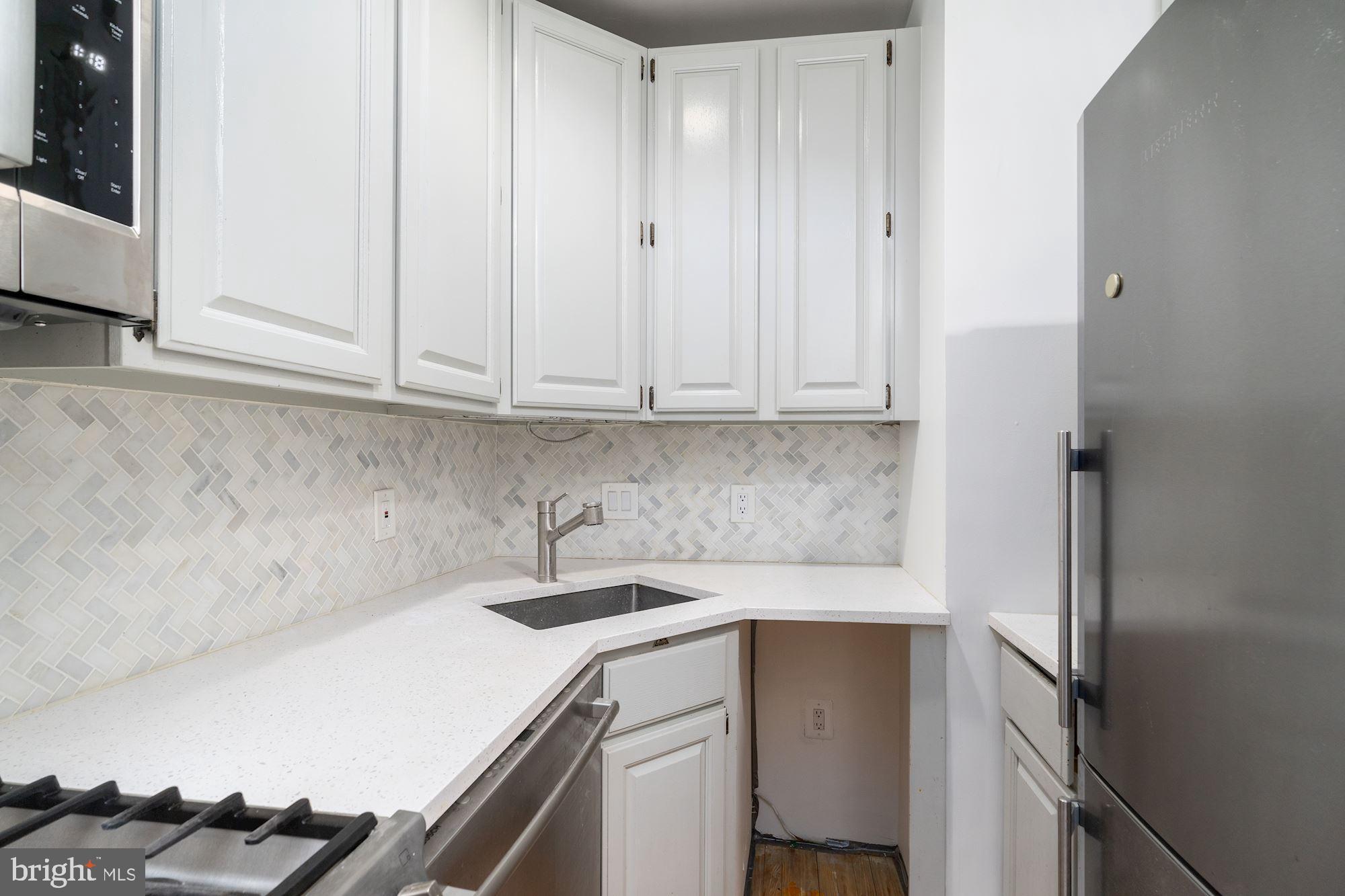 3267 N Street Northwest, Unit 2 Washington, DC 20007 - Photo 12 of 21 a kitchen with a sink and cabinets