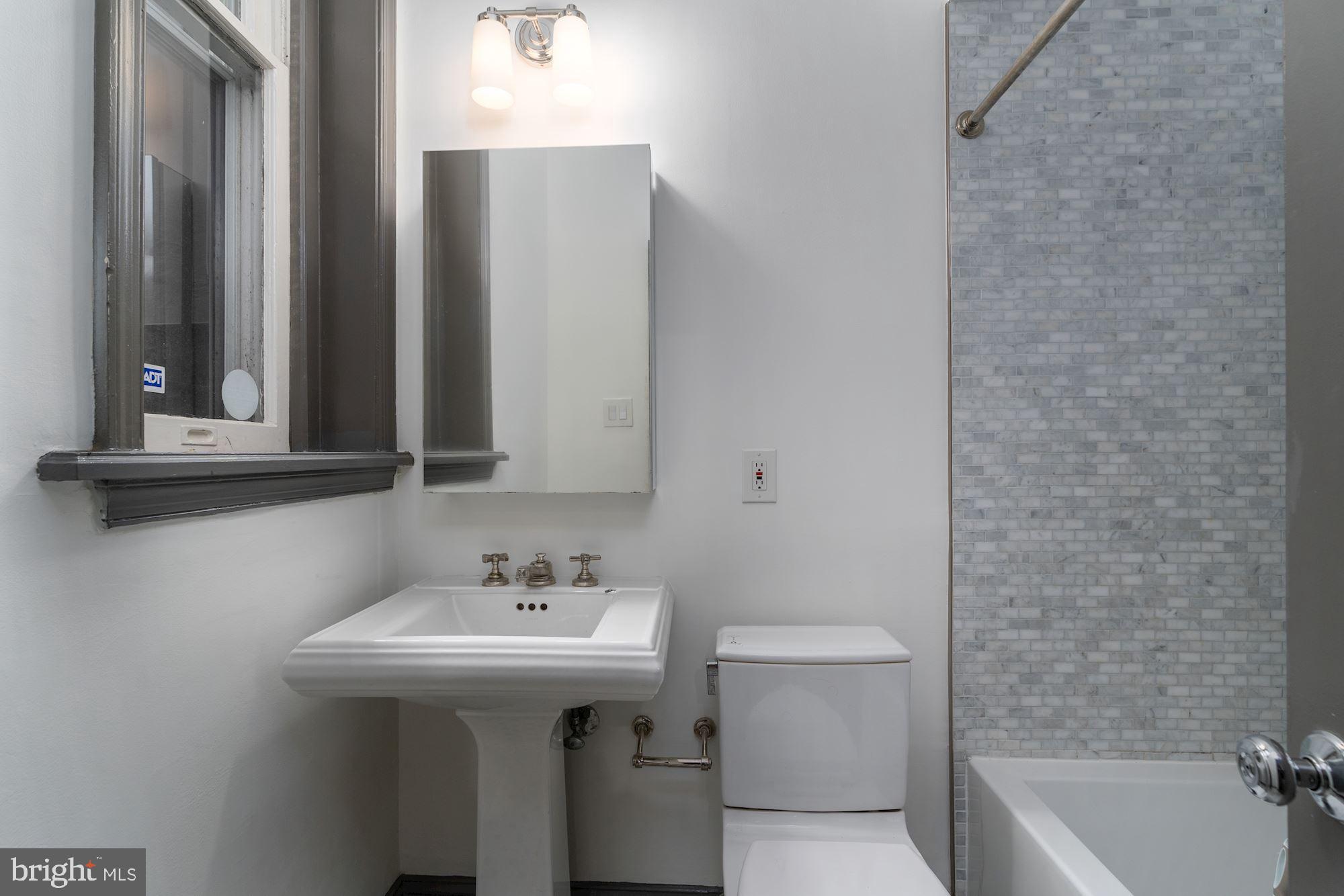3267 N Street Northwest, Unit 2 Washington, DC 20007 - Photo 13 of 21 a bathroom with a sink a toilet and shower