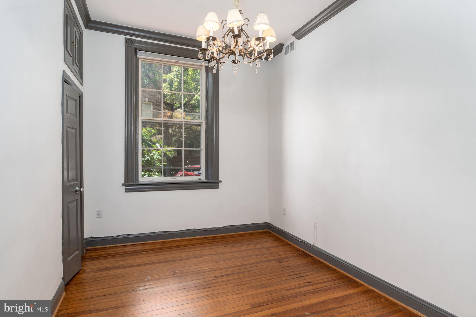 3267 N Street Northwest, Unit 2 Washington, DC 20007 - Photo 15 of 21 a view of a livingroom with wooden floor and a window