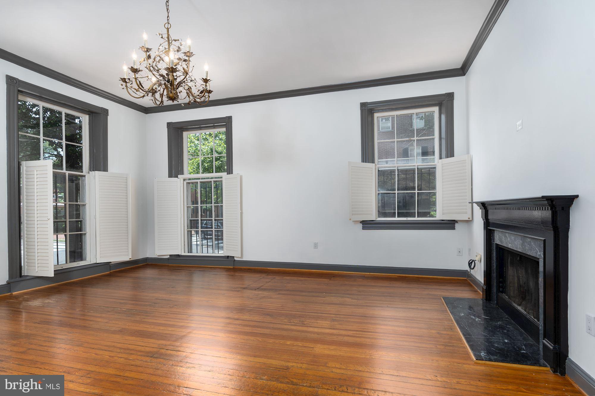 3267 N Street Northwest, Unit 2 Washington, DC 20007 - Photo 4 of 21 a view of an empty room with wooden floor and a window