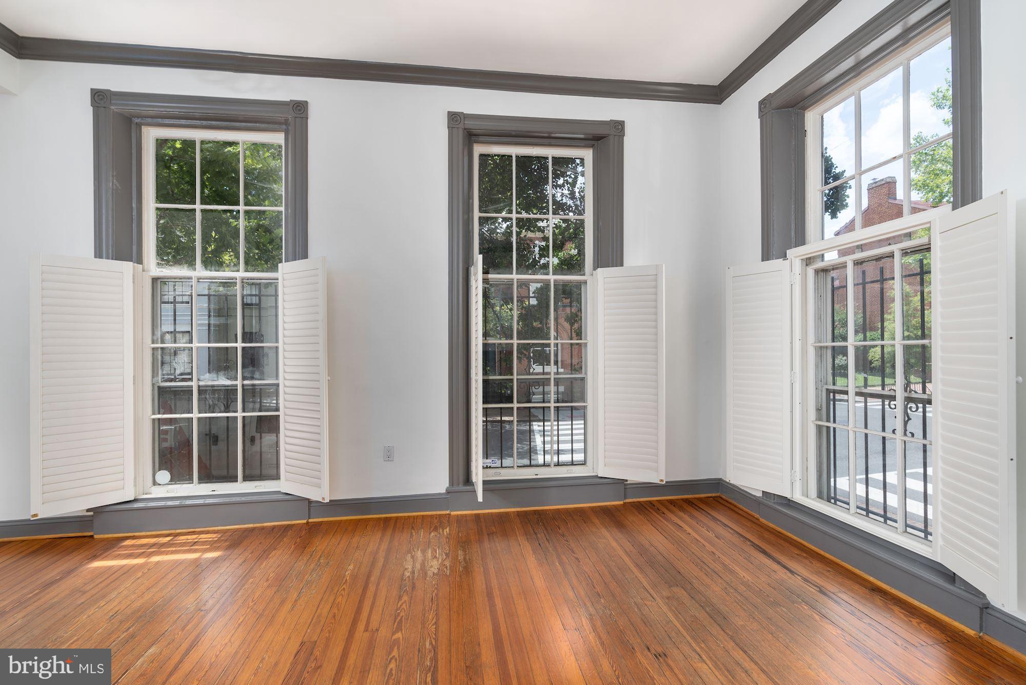 3267 N Street Northwest, Unit 2 Washington, DC 20007 - Photo 5 of 21 an empty room with wooden floor and windows