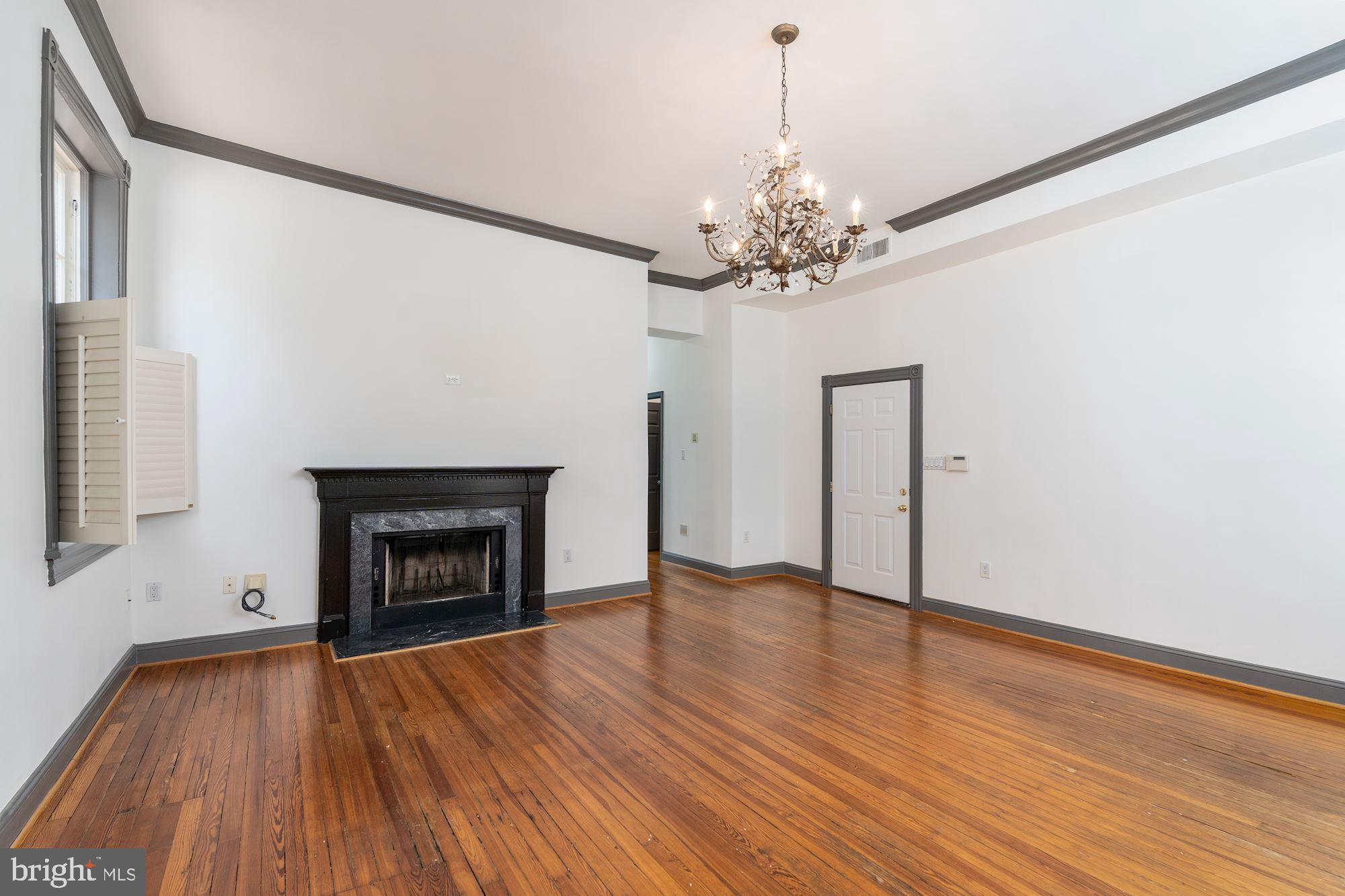3267 N Street Northwest, Unit 2 Washington, DC 20007 - Photo 6 of 21 a view of an empty room with wooden floor and a window