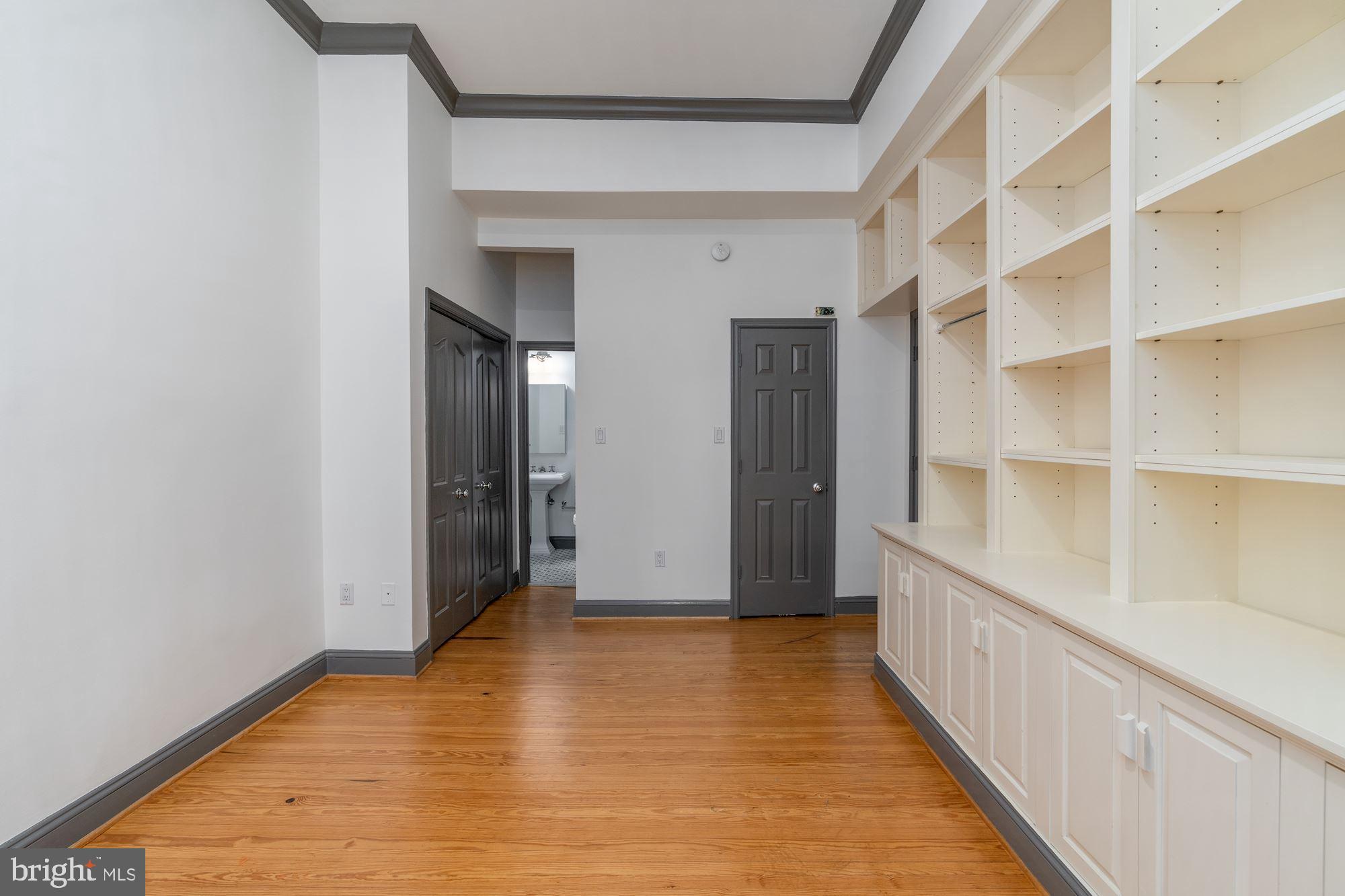 3267 N Street Northwest, Unit 2 Washington, DC 20007 - Photo 9 of 21 a view of an empty room with wooden floor and a window