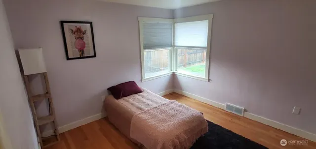 a bedroom with a bed and window